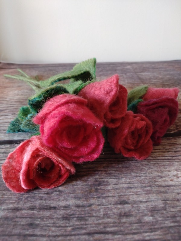 six red hand felted roses